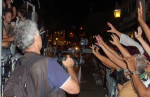 The crowd reaches out for beads thrown from passing floats.