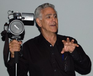 Carl demonstrates camera techniques during "backpack" journalism presentation.